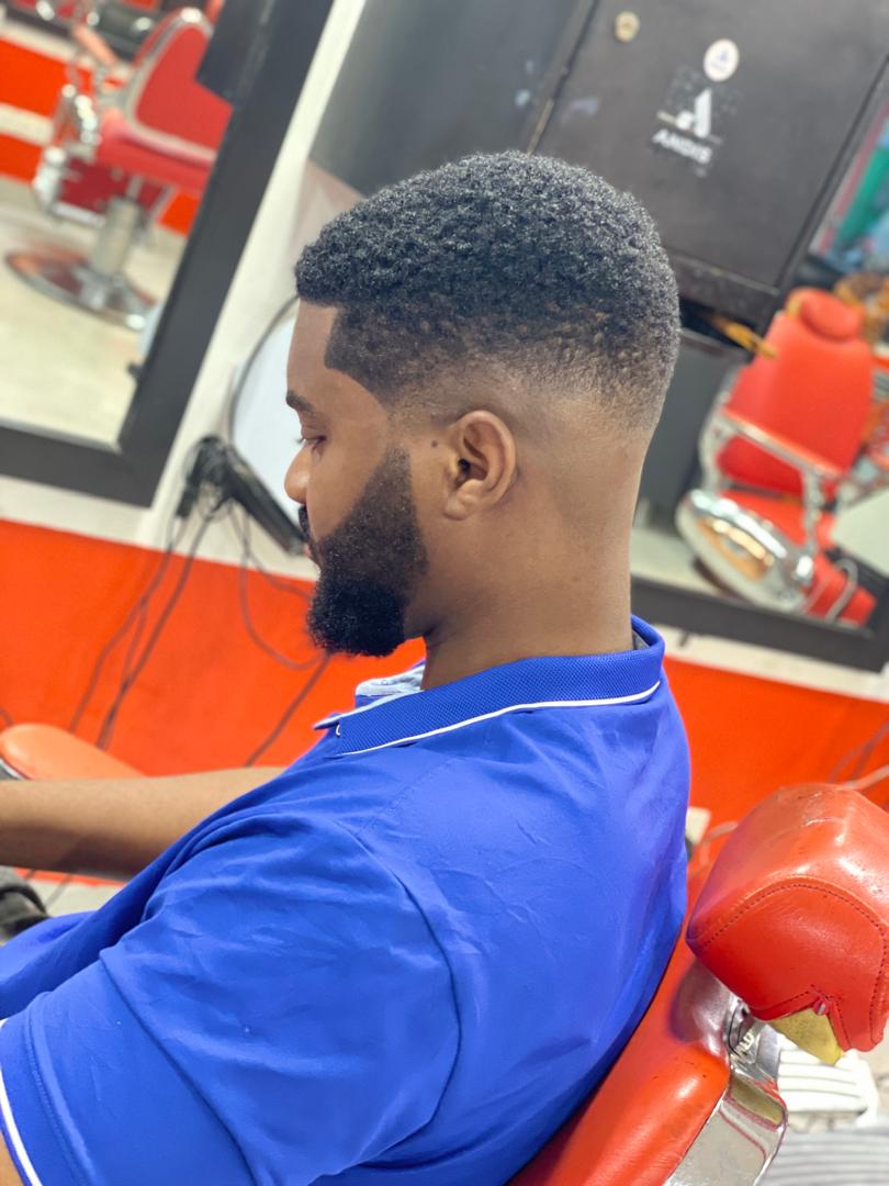 Completed high-end mid fade haircut and beard grooming